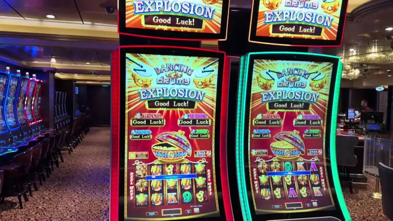 Anthem of the Seas casino video frame showing Dancing Drums Explosion, 5 Treasures Explosion.