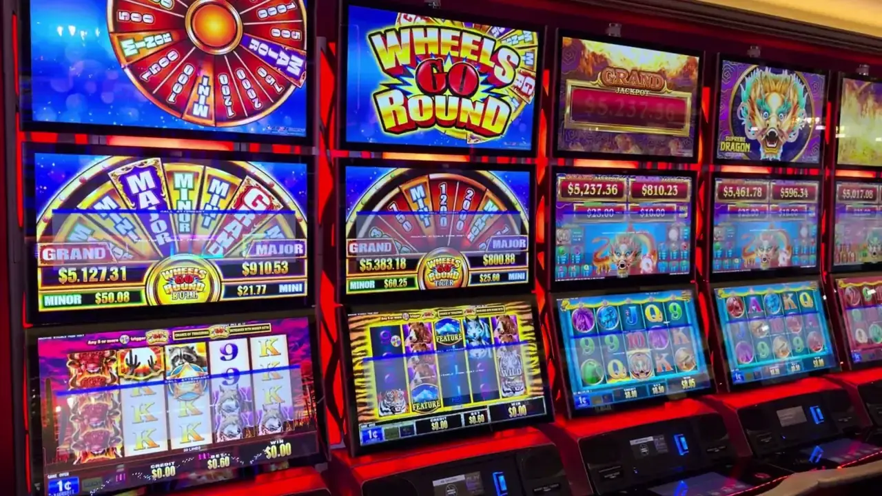 Anthem of the Seas casino video frame showing Wheels Go Round: Bull, Wheels Go Round: Tiger, Supreme Dragon Boost.