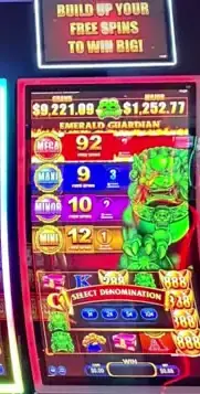 Emerald Guardian title and game screen on a Celebrity Apex slot cabinet