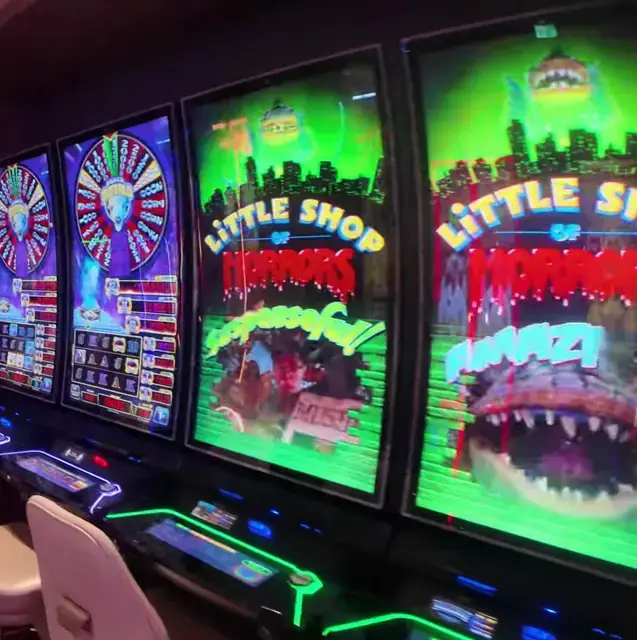 Little Shop of Horrors bank visible on illuminated cabinets aboard Wonder of the Seas.