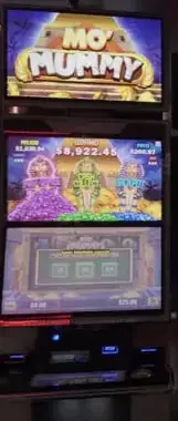 Mo' Mummy title and game screens visible on a Celebrity Ascent slot cabinet