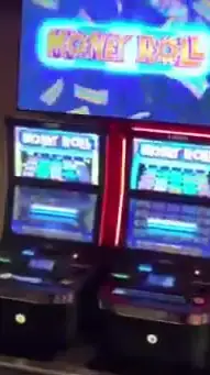 Money Roll title above Celebrity Infinity slot cabinets