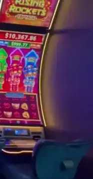 Rising Rockets title visible on a Celebrity Apex slot cabinet