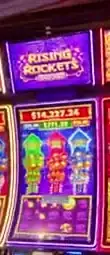 Rising Rockets title above Celebrity Reflection slot cabinets
