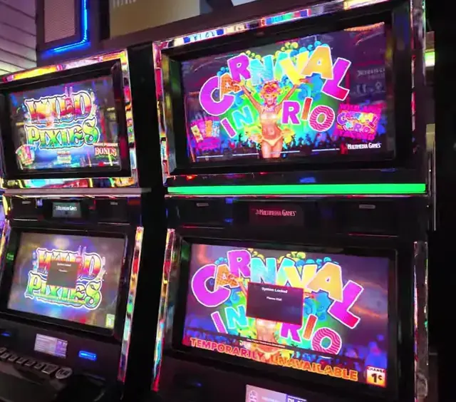 Slot cabinets showing Wild Pixies, Carnival in Rio aboard Enchantment of the Seas.