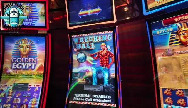 Slot cabinets showing Golden Egypt, Wrecking Ball aboard Enchantment of the Seas.