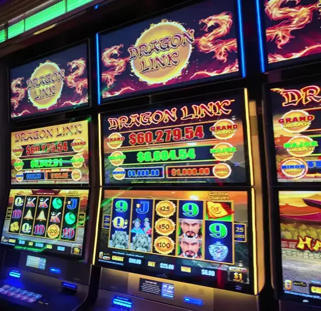 Slot cabinets showing Dragon Link: Golden Century aboard Enchantment of the Seas.