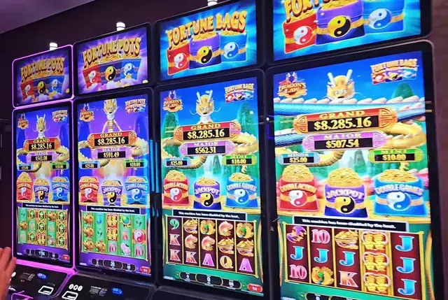 Slot cabinets showing Dragon’s Law: Fortune Pots, Dragon’s Law: Fortune Bags aboard Icon of the Seas.
