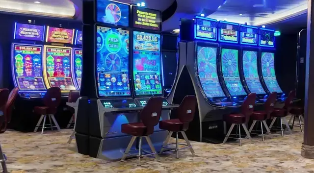 Slot cabinets showing Rising Rockets, Piggy Pennies aboard Symphony of the Seas.