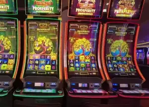 Wealth of Prosperity title above linked slot cabinets on Celebrity Reflection